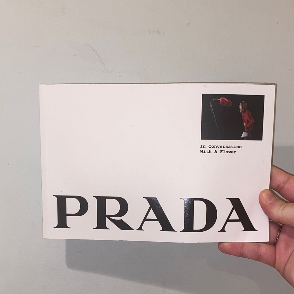 Prada Cream Booklet with Black and Red Accents